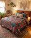 Cozy bedroom with a colorful floral comforter, patterned pillows, woven wall art, string lights, plants, a rattan chair, and sunlight coming through a window with sheer curtains.