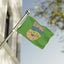 A vibrant green Epic Playlist Society | Festival Totem | Campsite Flag featuring colorful, wavy “EPIC PLAYLIST SOCIETY” text waves on a flagpole against a blue sky and blurred tree branches—an ideal emblem for music lovers and the ultimate accessory for any festival campsite.