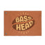 Introducing the Bass Head Festival Flag New: a brown festival flag featuring the words “BASS HEAD” in bold, retro yellow text displayed between two coffee bean shapes. Perfect as a rave flag or festival totem, it comes with two metal grommets on the left side for easy display.