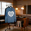 A blue hoodie with the text "Disco Tribe Co" is hanging on a clothing rack in a room with a record player and turntables.