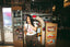 A woman stands in a diner by a jukebox, sipping a milkshake with a straw held to her lips. She wears patterned pants and The Bender Crop, effortlessly channeling music festival outfit vibes. The diner features vintage decor and bright signage.