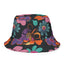The Electric Petals Bucket Hat is a black Y2K-inspired accessory adorned with bold, colorful floral patterns in vibrant orange, purple, pink, and teal hues—making it the perfect boho festival hat to bring a playful pop to any outfit.