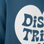 A close-up view of a blue fabric with a white text logo on it.